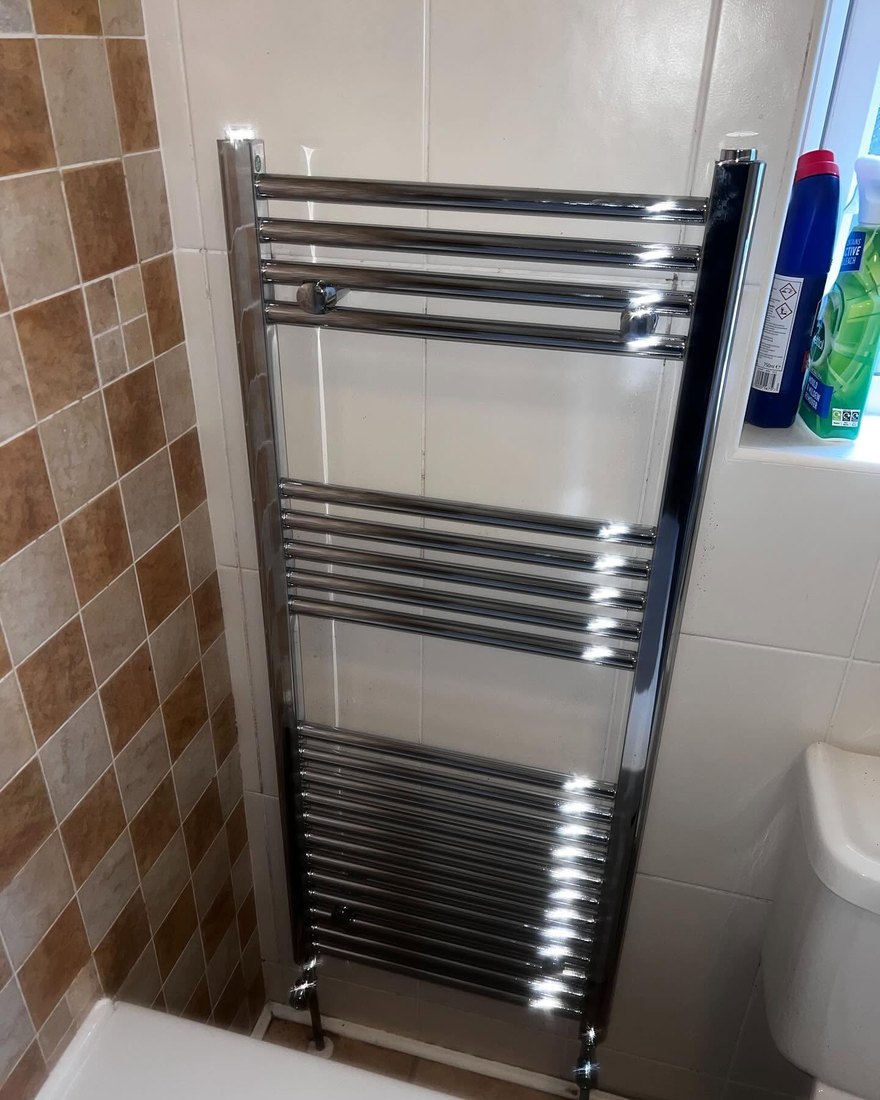Chrome heated towel radiator fitted in a bathroom