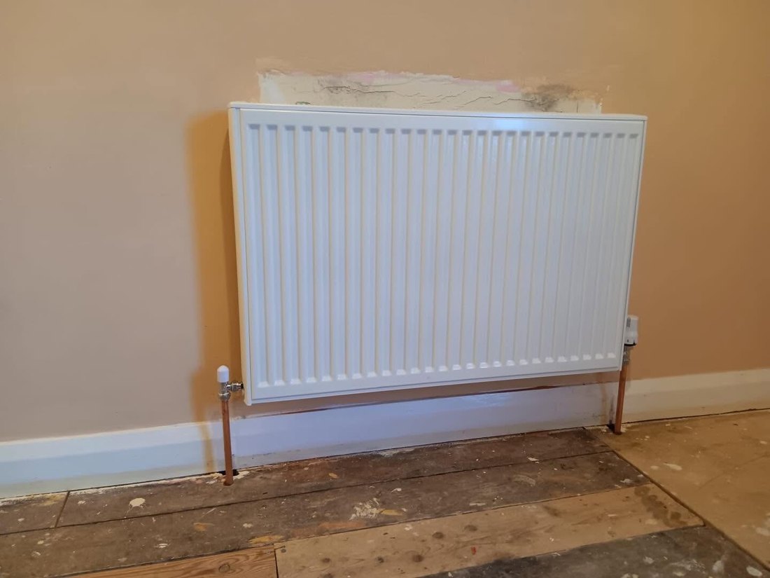 New white radiator fitted with thermostatic valve
