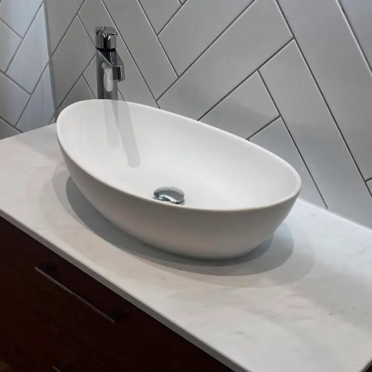 White vessel basin and tap on a vanity unit
