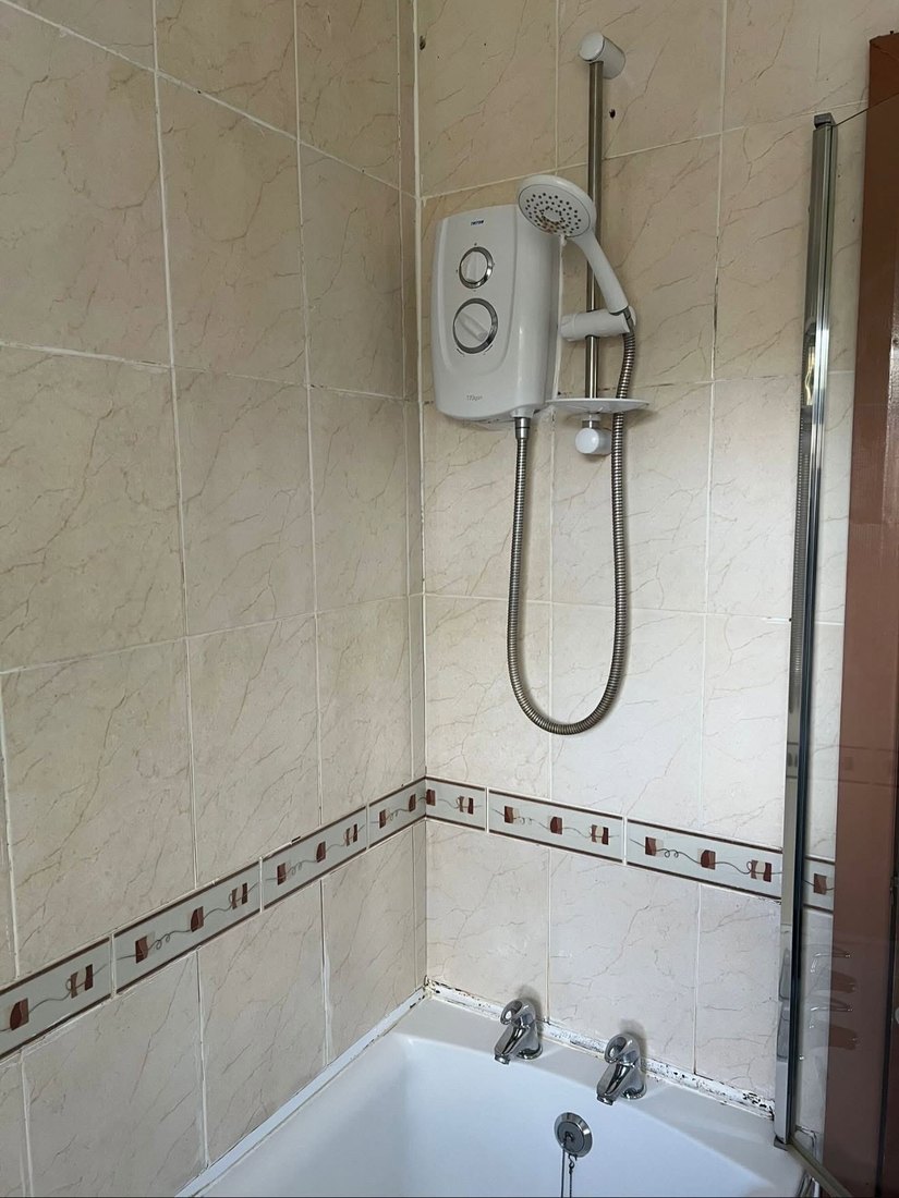 Triton electric shower fitted over a bath